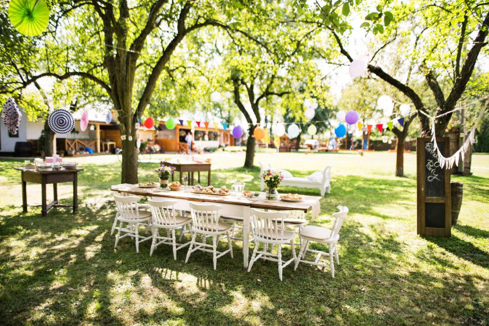 Garden setup with birthday tables and chairs arranged outdoors
