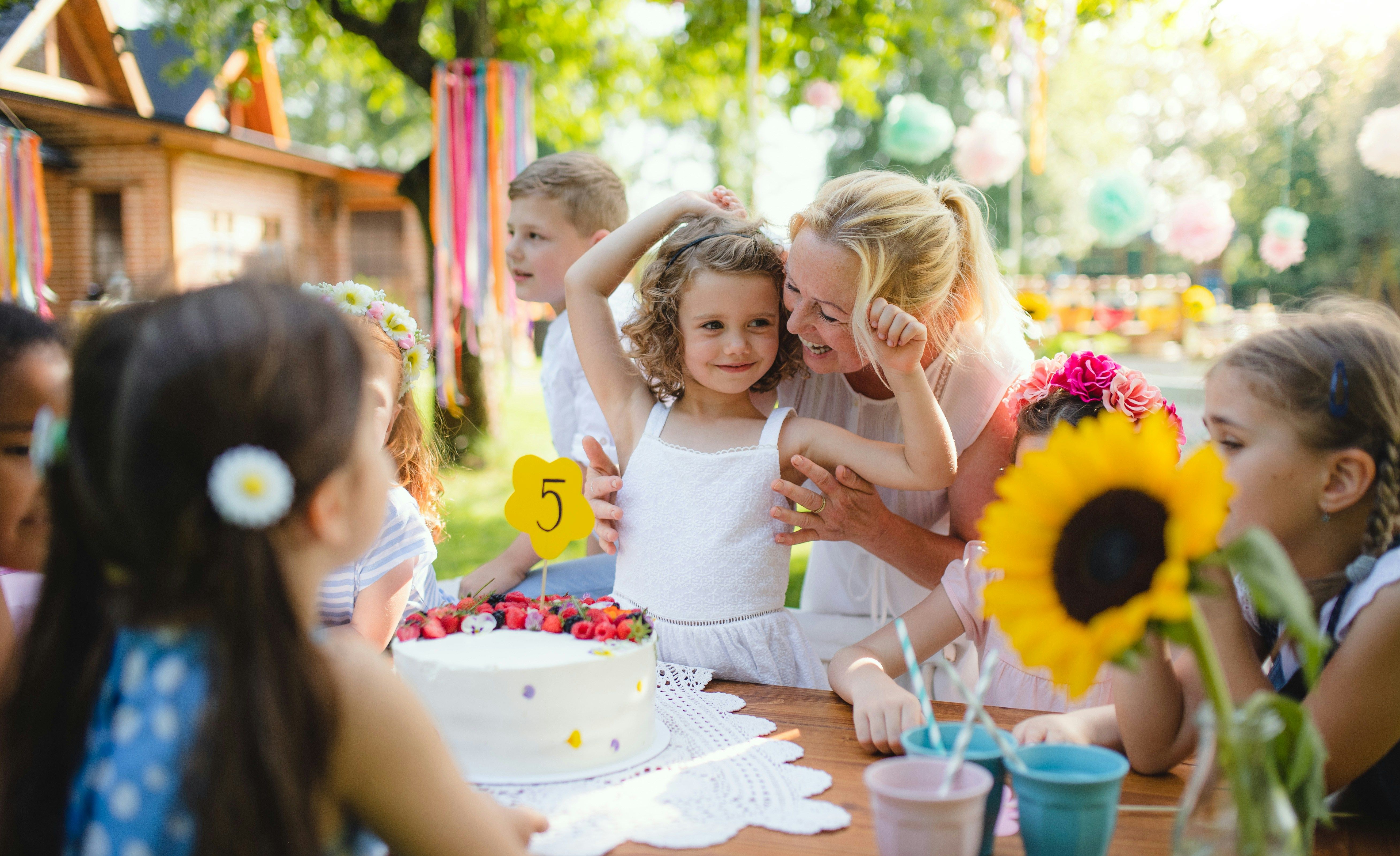 Parents and kids enjoying an outdoor picnic birthday
