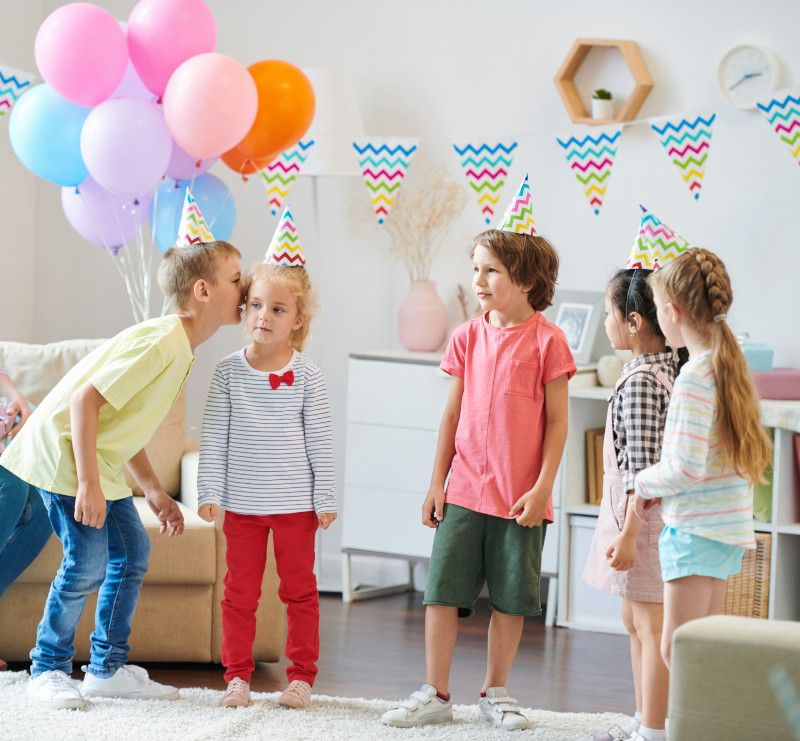 Kids playing musical chairs indoors during a birthday party