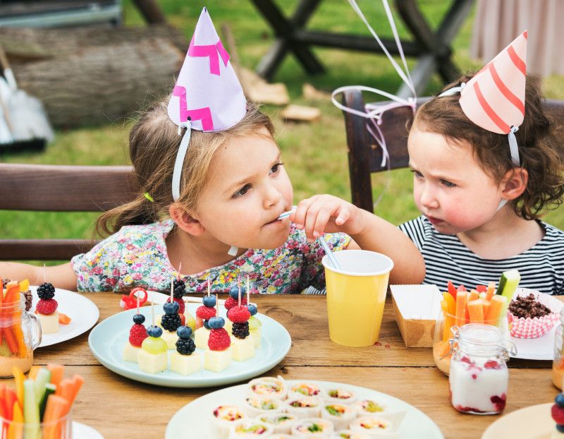 Colorful birthday snacks and treats on a kids party table