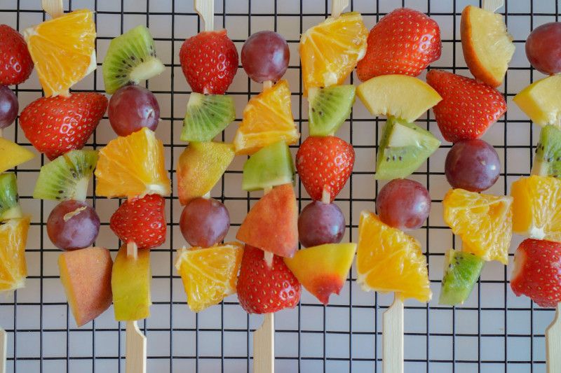Colorful fruit skewers arranged on a birthday table