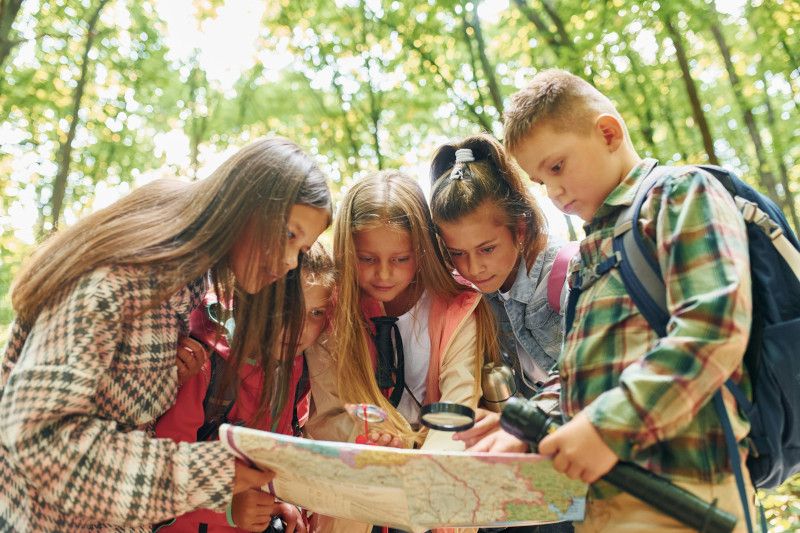 Children playing a treasure hunt game outdoors