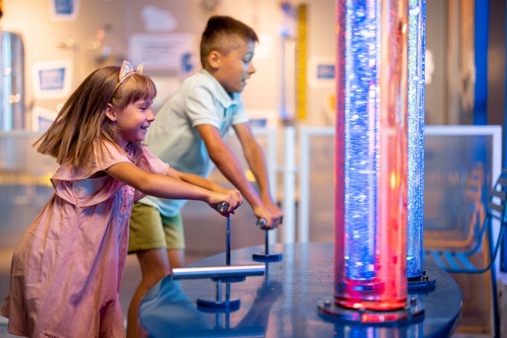 Children exploring a kids' exhibit in a museum during a birthday visit