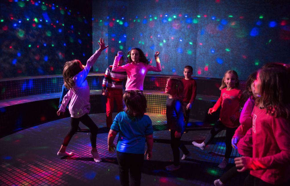 Children dancing in a bright studio during a birthday party